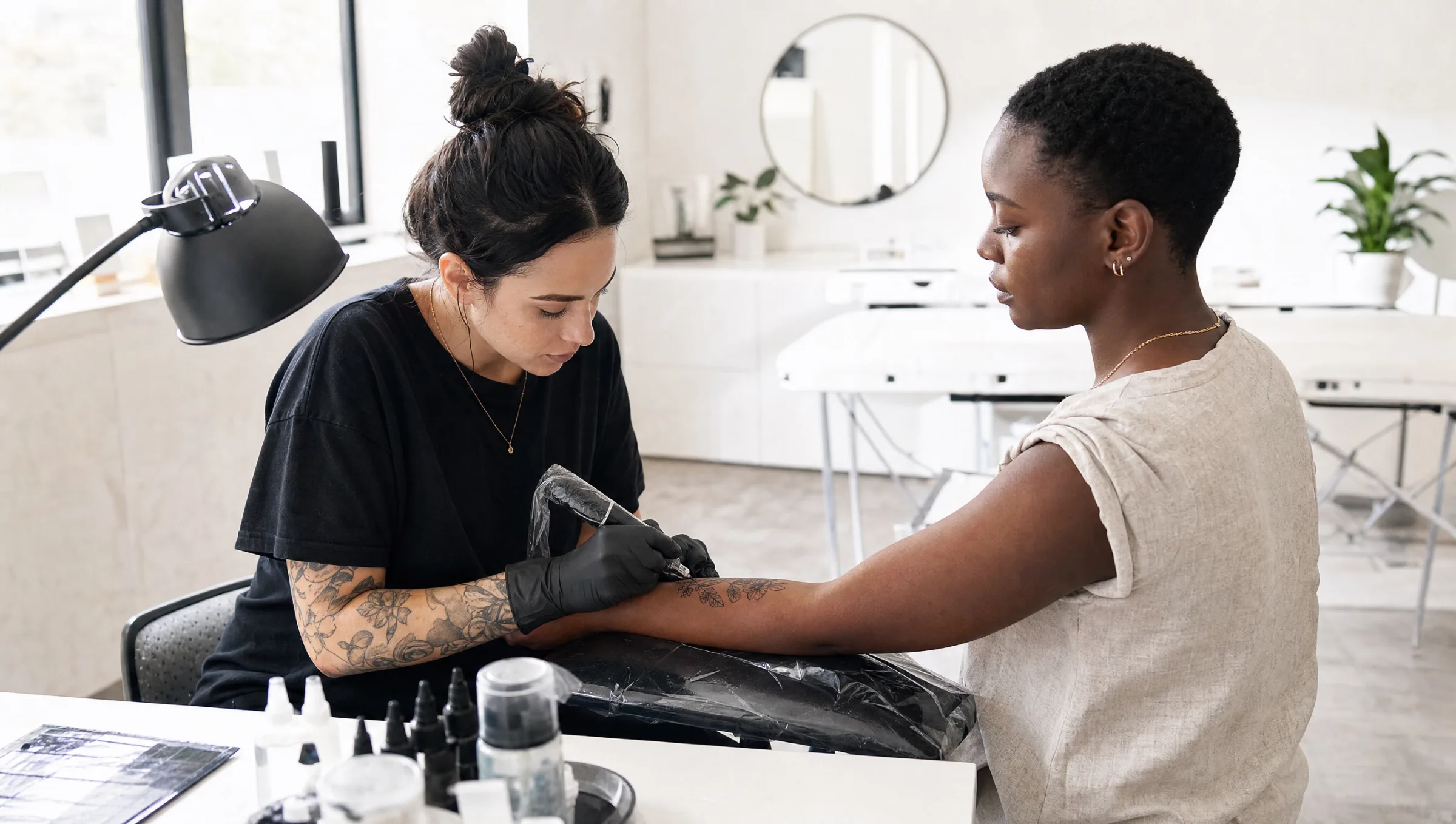 Bright, minimal tattoo studio interior with a clean workstation and natural light